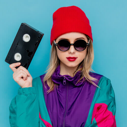 woman with VHS cassette ready to backup video