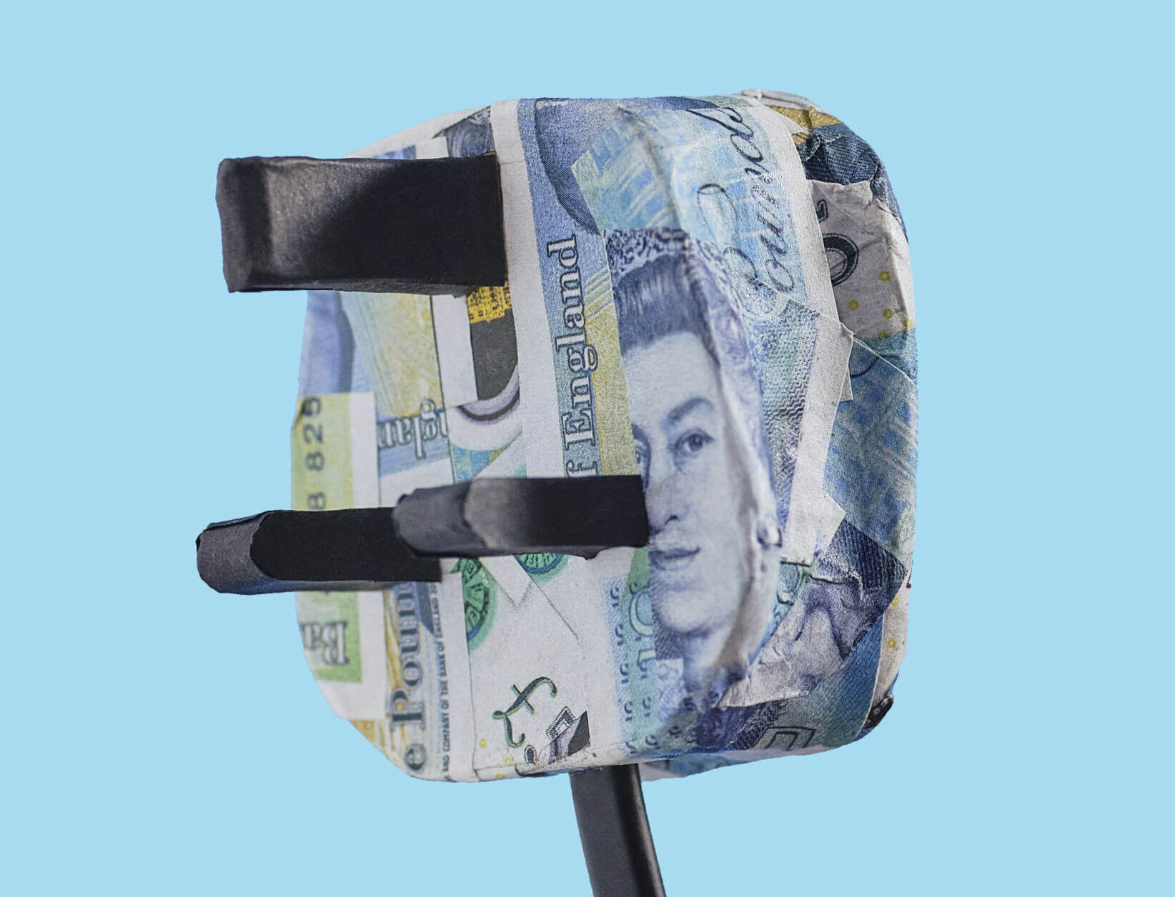 Origami plug cyan 2024 1644x1256 px close up of a three pin plug that has been decoupaged with five pound notes